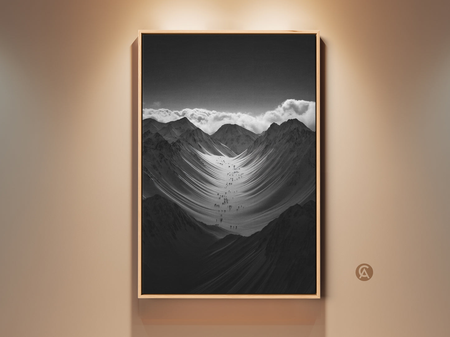 Modern monochrome mountain art print displayed in a floating frame. A group of hikers are ascending a vast snowy mountain range. It's a perfect gift for hikers and climbers. This nature scenery wall art adds adventure to any space.