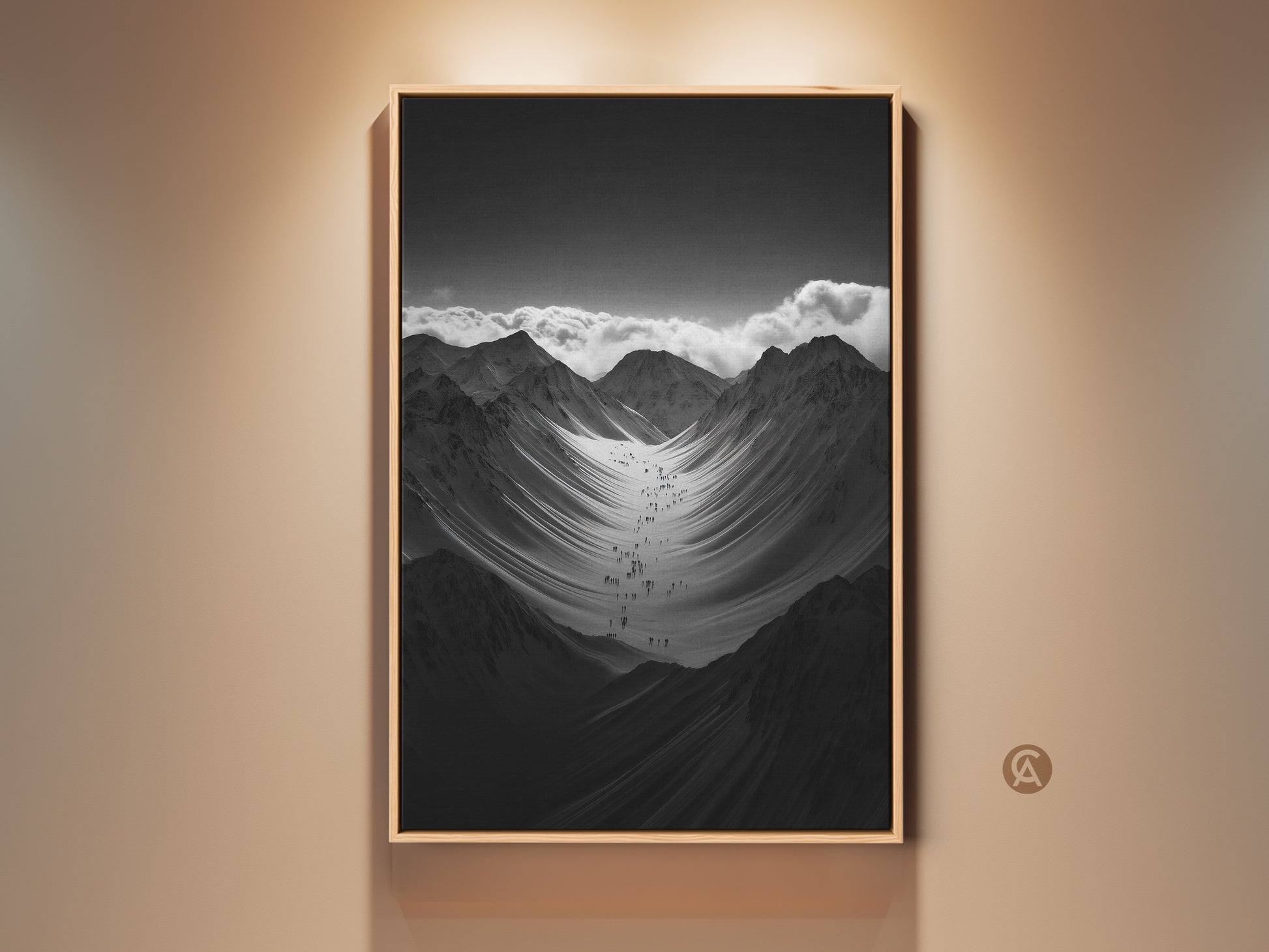 Modern monochrome mountain art print displayed in a floating frame. A group of hikers are ascending a vast snowy mountain range. It's a perfect gift for hikers and climbers. This nature scenery wall art adds adventure to any space.