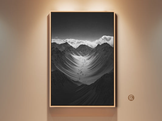 Modern monochrome mountain art print displayed in a floating frame. A group of hikers are ascending a vast snowy mountain range. It's a perfect gift for hikers and climbers. This nature scenery wall art adds adventure to any space.