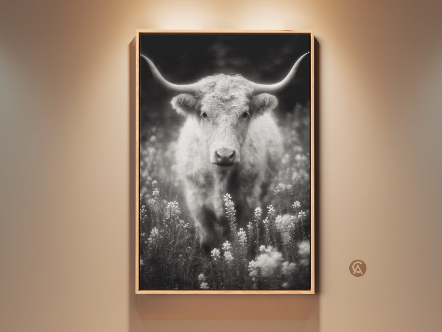 Black and white longhorn art print. The fine art photograph features a Texas Longhorn in a field of wildflowers. This wall art is framed in a natural wood finish. The artwork captures the rustic beauty of the American Southwest