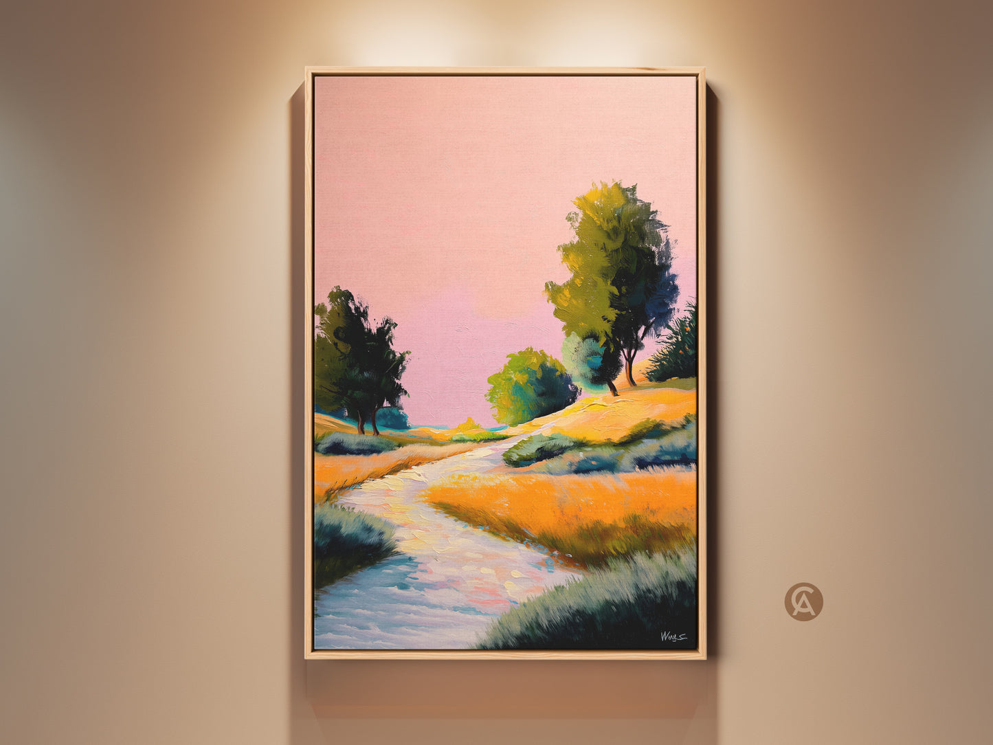 Framed pink yellow orange landscape canvas art is hung against a beige wall. The boho river trees print has an impressionistic style. This expressive nature wall decor makes a great bedroom art gift.