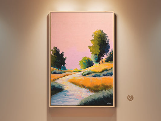 Framed pink yellow orange landscape canvas art is hung against a beige wall. The boho river trees print has an impressionistic style. This expressive nature wall decor makes a great bedroom art gift.