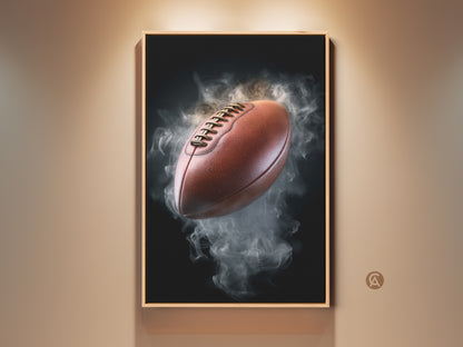 Framed smoke football canvas art print displayed on a wall. This modern office artwork features a brown football emerging from gray smoke. Perfect sports fan gift for a man cave or professional office decor.