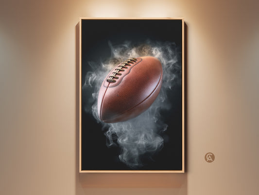 Framed smoke football canvas art print displayed on a wall. This modern office artwork features a brown football emerging from gray smoke. Perfect sports fan gift for a man cave or professional office decor.
