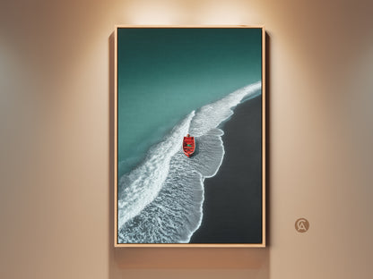 Framed minimalist beach artwork. Teal ocean meets a dark sand shore. A red boat adds a pop of color. This coastal canvas art is framed in oak. Perfect nautical home gift or housewarming art.