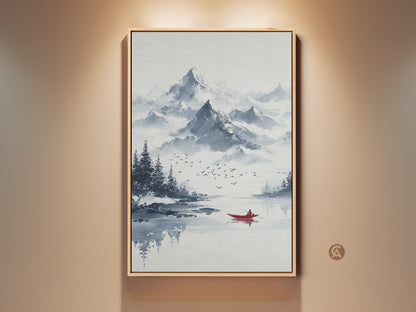 Framed minimalist mountain art print. This ink wash lake scene features a red canoe. It is perfect wall decor for Scandinavian bedrooms. The blue and gray nature landscape creates a serene ambiance.
