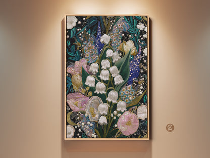 Framed Lily of the Valley & Tulip Embroidery Art Print on a beige wall. The artwork features a textured nature print with pink white and teal floral decor. This botanical wall art adds spring charm to any maximalist home decor.