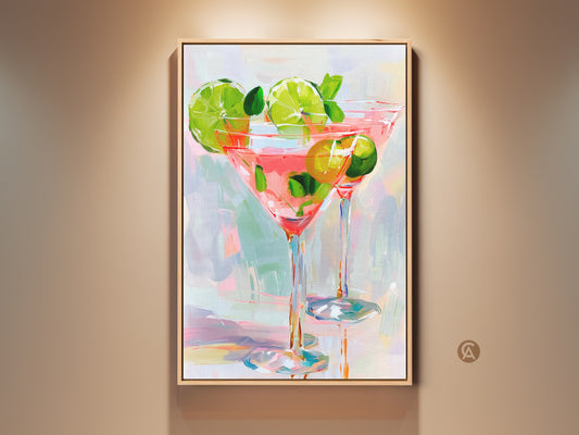 Framed canvas art displaying two cocktail glasses filled with a pink beverage. Limes and mint garnish the drinks. The artwork has a modern impressionist style. This painting is a great addition to a kitchen or bar area.