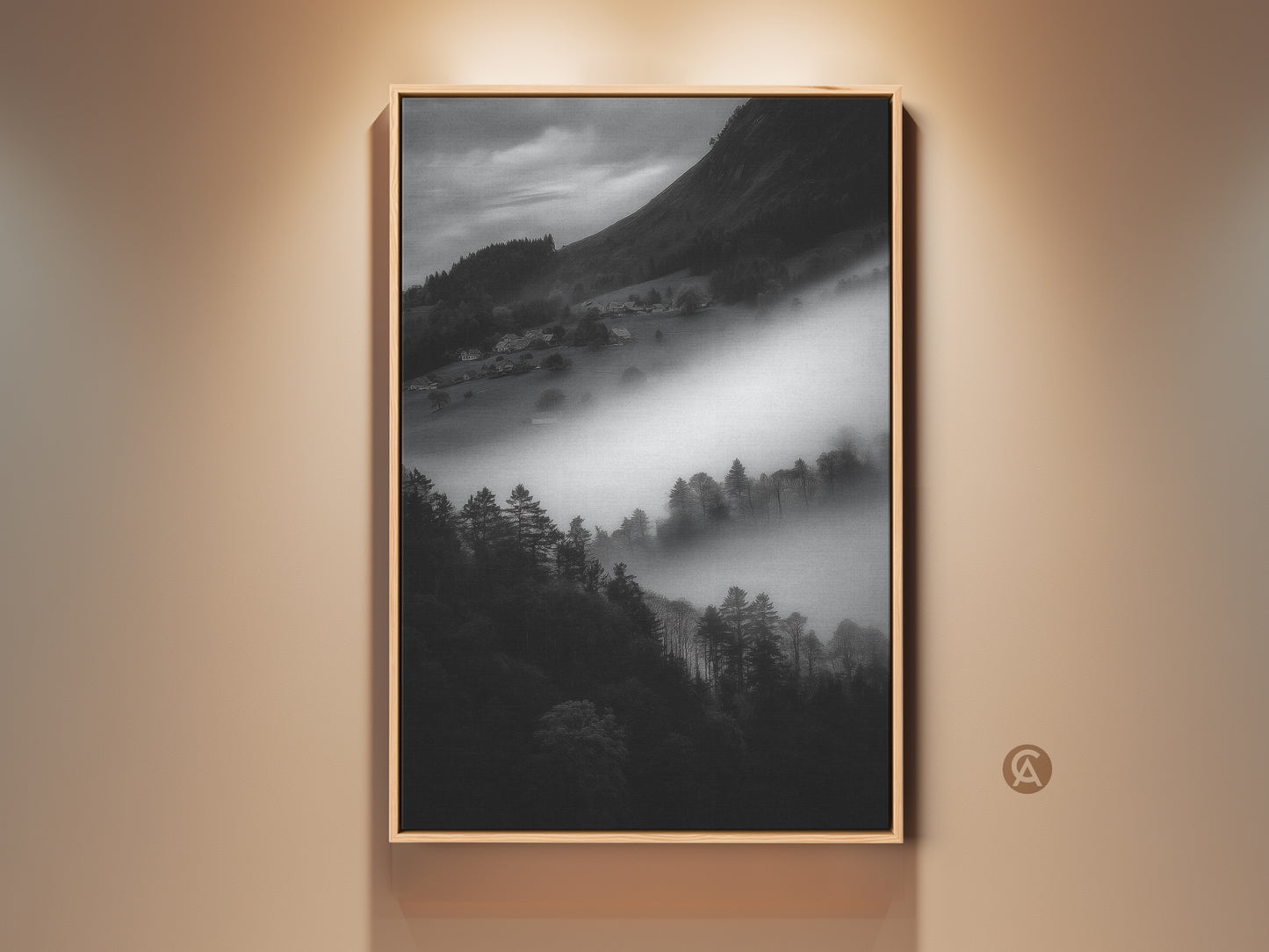 Framed black and white mountain art print. This monochrome landscape canvas wall art captures a foggy village scene. Contemporary nature scene decor makes a perfect housewarming gift. The black frame enhances the neutral wall art.