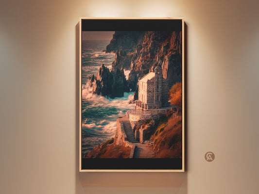 Coastal stone house art print framed in a warm wood tone. The rocky cliffs and deep blue teal ocean create a dramatic seascape. This nautical art is perfect for a living room or entry way.