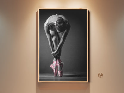 Framed ballerina art print. This artwork features a dancer in a graceful pose. The dancer is wearing pink pointe shoes. It is ready to hang and adds elegance to any room.