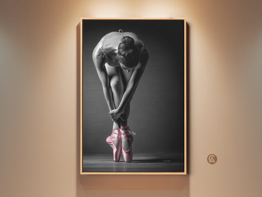 Framed ballerina art print. This artwork features a dancer in a graceful pose. The dancer is wearing pink pointe shoes. It is ready to hang and adds elegance to any room.