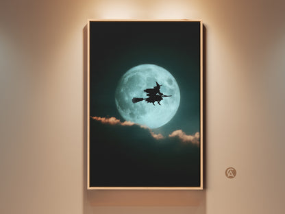 Framed teal moon witch canvas art hangs on a wall. The artwork features a witch silhouette against a bright teal moon. This gothic Halloween art is perfect eclectic bedroom decor or a witchy gift.