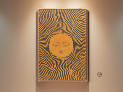 A framed celestial sun art print hangs on a beige wall. This boho abstract sun face wall decor features mid-century orange and yellow rays. The canvas adds warmth and artistic flair to any room. This spiritual sun face decor is a unique housewarming gift.