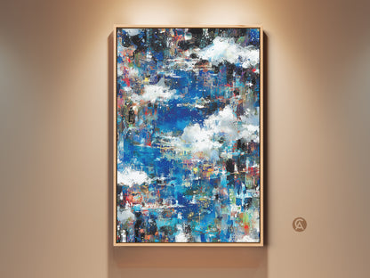 Abstract artwork with blue and white hues. The painting is displayed in a light wood frame. Modern art piece perfect for adding a touch of color to any room. Shop now to elevate your home decor with this unique canvas art.