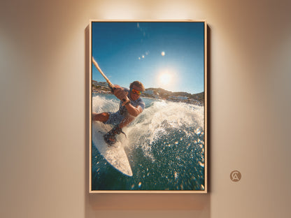 A man water sports in a vibrant ocean. The sun shines brightly in the sky. This action shot captures the thrill of wakeboarding. This artwork is framed for a modern aesthetic. It enhances any room with an adventurous spirit.