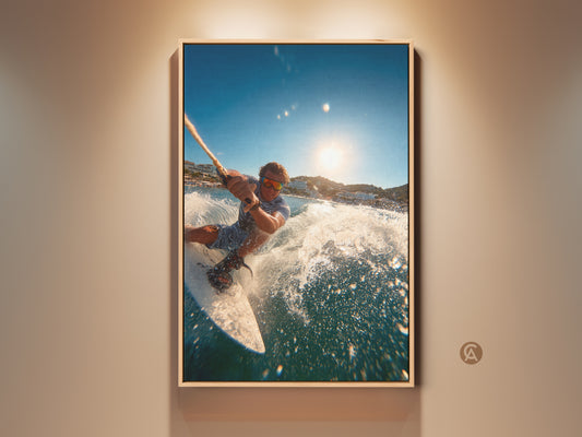 A man water sports in a vibrant ocean. The sun shines brightly in the sky. This action shot captures the thrill of wakeboarding. This artwork is framed for a modern aesthetic. It enhances any room with an adventurous spirit.