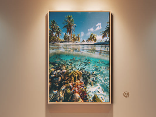 Framed split view ocean canvas art print displayed on a wall. This tropical beach artwork captures a serene island paradise. Palm trees line the sandy shore above the water. A vibrant coral reef teeming with marine life is visible below. Coastal wall decor brings the beauty of the ocean indoors. Perfect housewarming gift for ocean lovers.