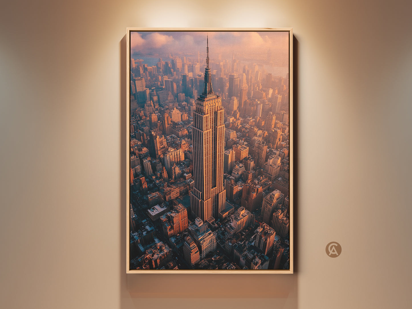 Framed Empire State Building art is showcased in a natural wood floating frame. The artwork captures an aerial view of the iconic New York City landmark. The warm sunset light enhances the architectural details of the city.