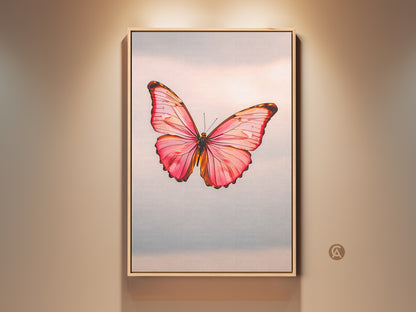 Framed minimalist butterfly art print in a room setting. The modern nature insect artwork features a pink peach and rose gold canvas. It's a bedroom office gift idea. The delicate butterfly art is a beautiful wall decor piece.