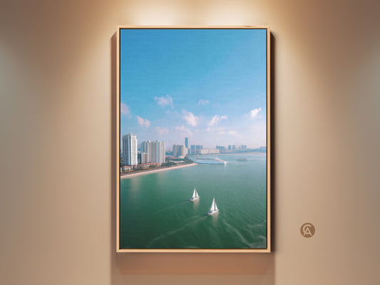 Modern aerial cityscape art on canvas with sailboats. This coastal ocean wall artwork brings a teal blue travel theme to a bedroom. The contemporary scene features a city skyline cruise ship and beach house nautical decor. It is a perfect housewarming gift for travel lovers adding blue green wall art to any space.