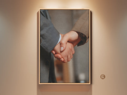 Handshake canvas art in a modern office setting. This business partnership wall decor features a neutral color palette. The artwork symbolizes collaboration and success. Perfect professional gift for an executive office. The gray and brown tones add sophistication to any workplace success art.