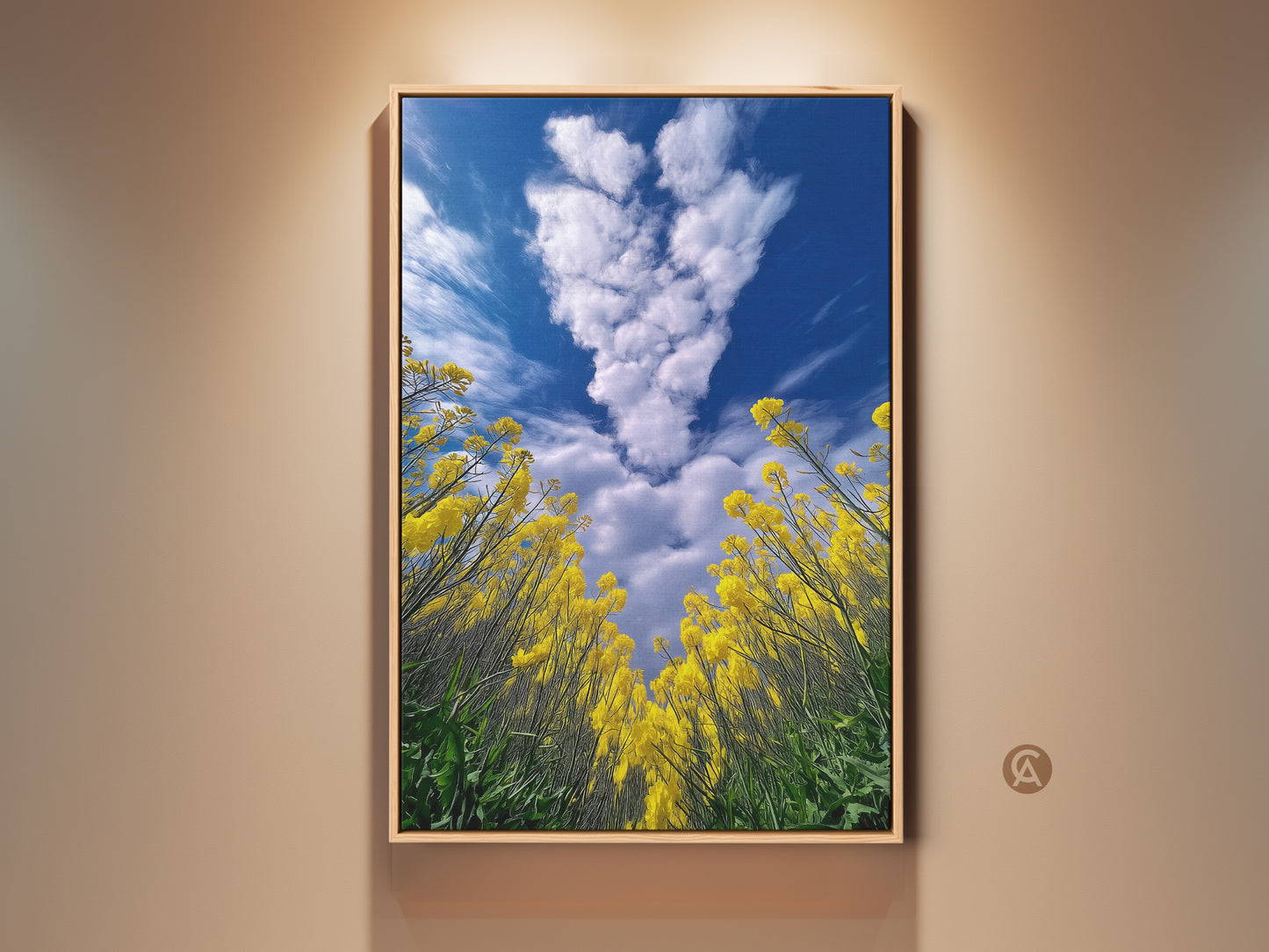 Framed yellow canola field artwork. Features a blue sky landscape canvas. This piece showcases boho floral nature decor. The impressionistic artwork is perfect for plant lovers. Bring the beauty of a summer field into your home with this scenic nature print.