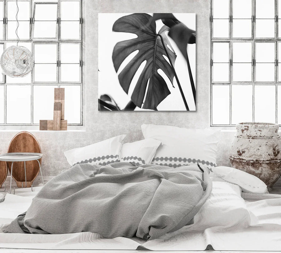 Monstera leaves in black and white—botanical canvas print on neutral wall