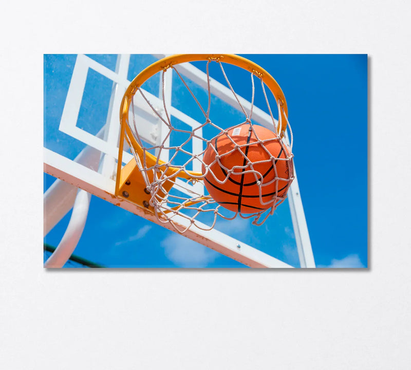 Basketball swishing through hoop under blue sky