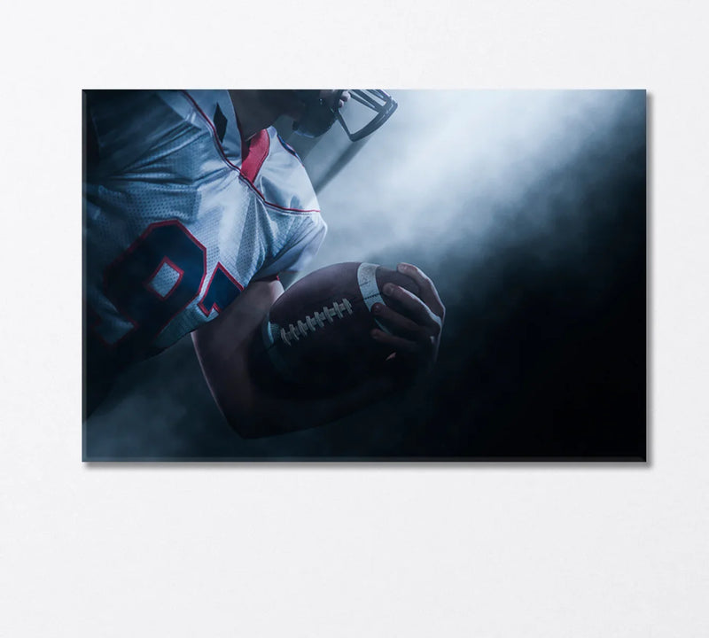 American football player holding the ball under stadium lights