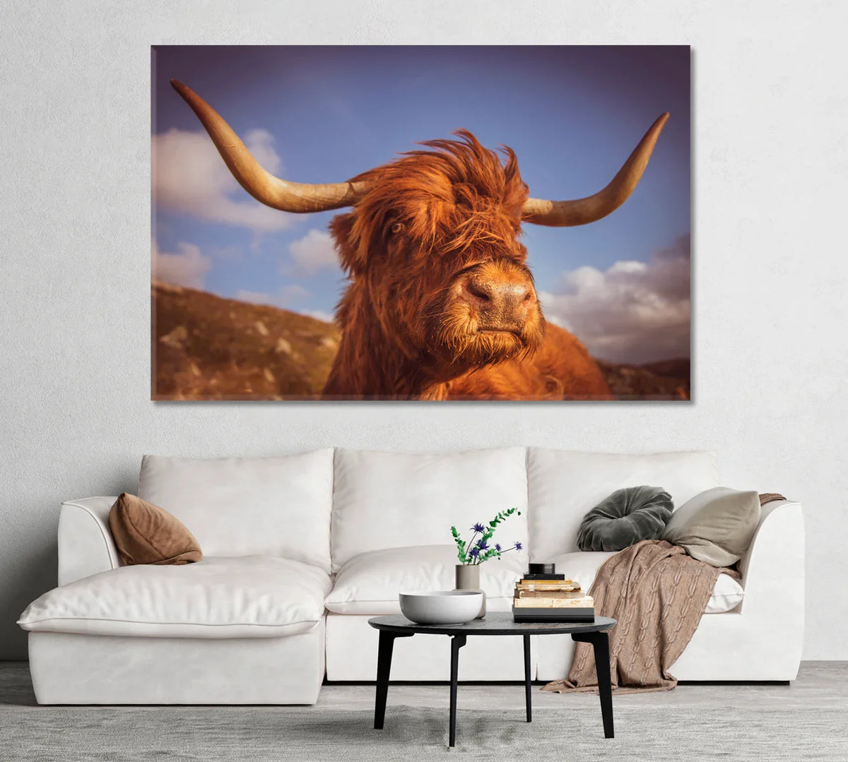 Hero: Highland Scottish cow canvas print above a cream sofa—warm neutrals and soft natural light in a modern farmhouse living room.