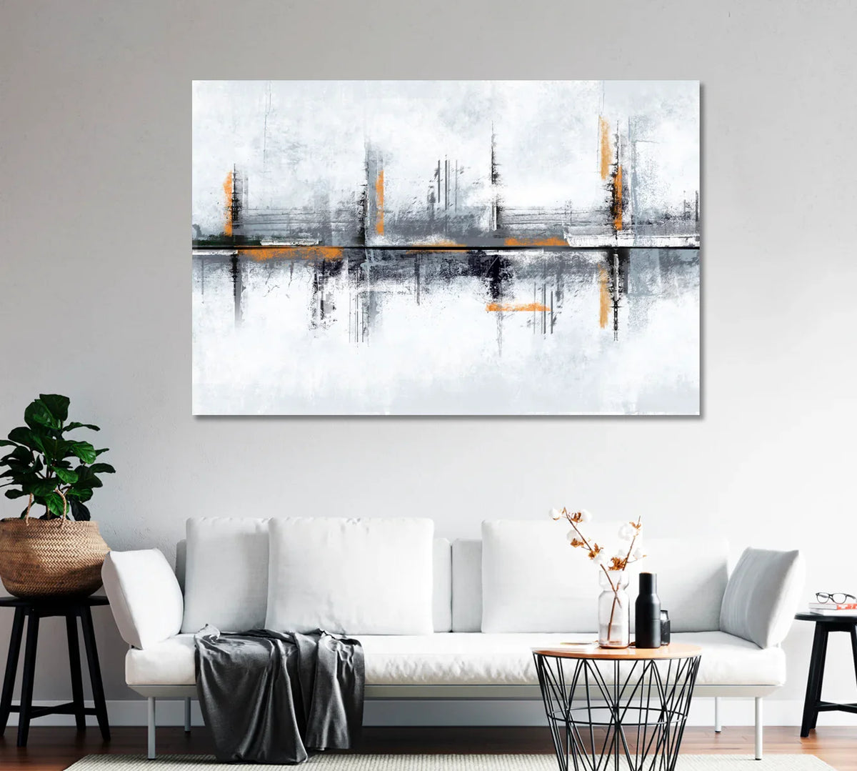 Large modern abstract canvas with cool greys and warm amber accents above a white sofa