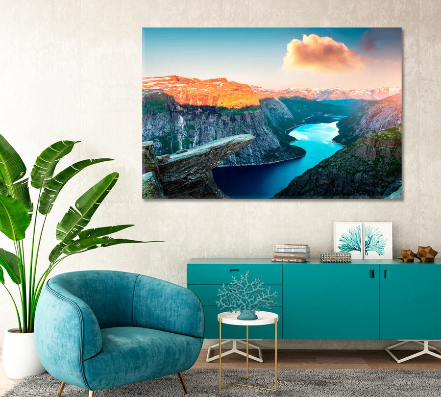 Trolltunga rock in Norway printed as a large canvas above a teal credenza