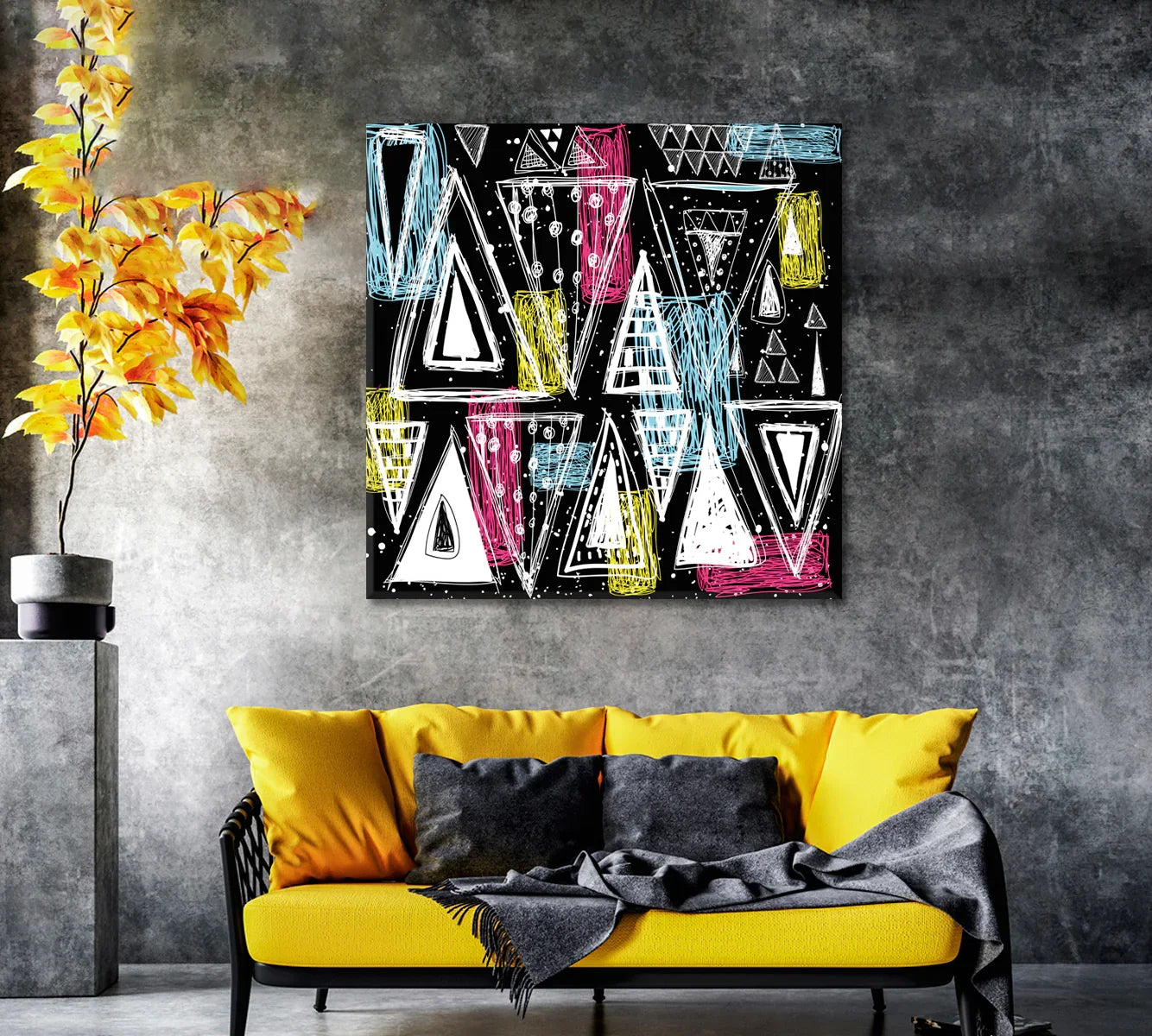 Graphic abstract canvas styled above a yellow sofa on a concrete wall