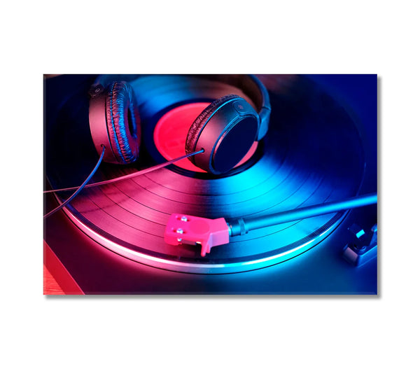 Black headphones resting on a vinyl record