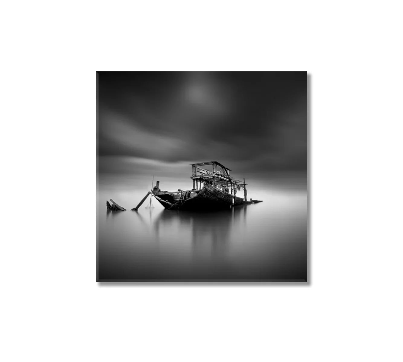 Black-and-white long-exposure of a sunken boat — minimal, calm, and quietly dramatic.