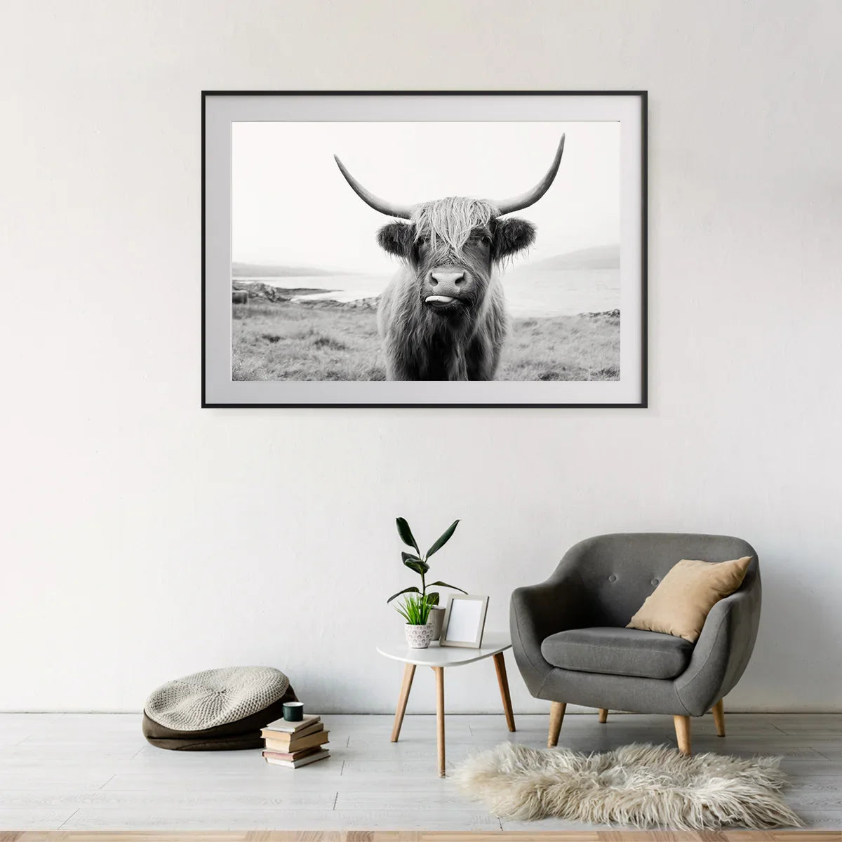 Black and white Highland cow art print in a minimalist reading corner—monochrome calm for modern farmhouse spaces.